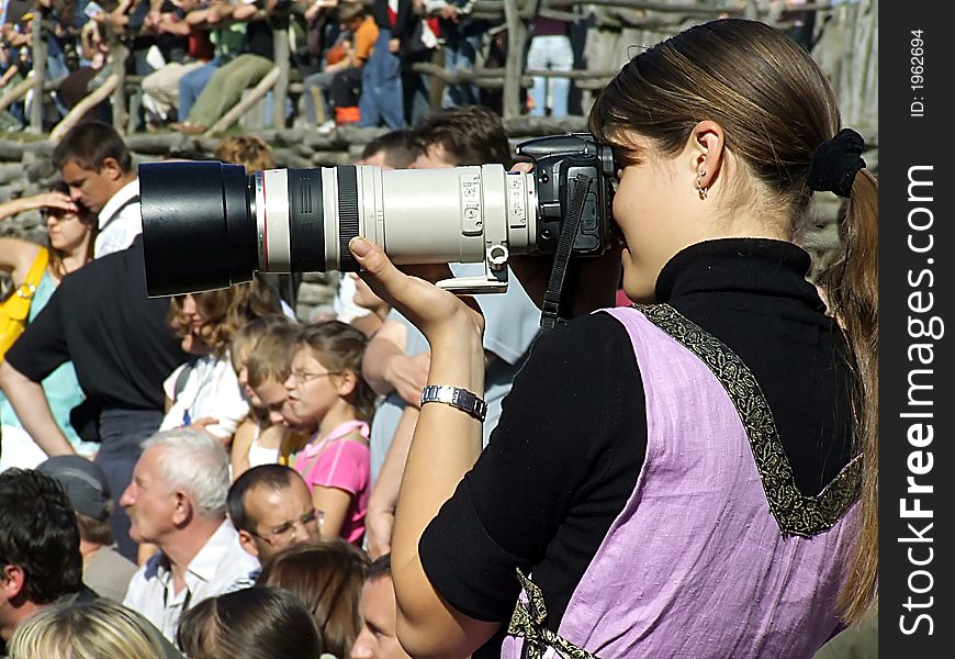 Nice young girl with camera taking picture