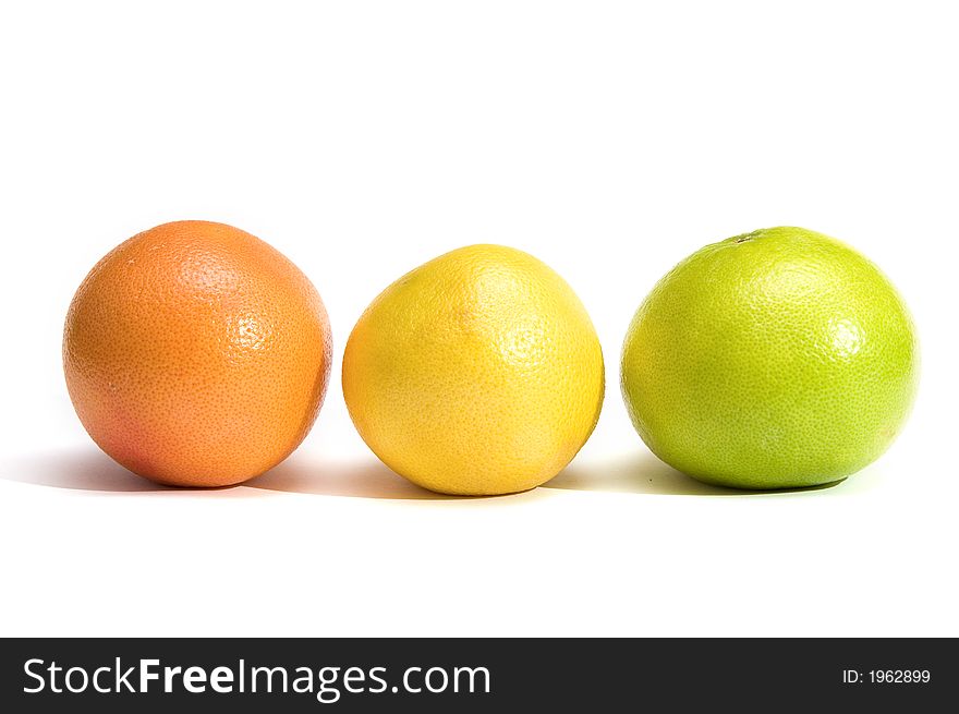 Orange and two grapefruits in a row on white background, three different colors