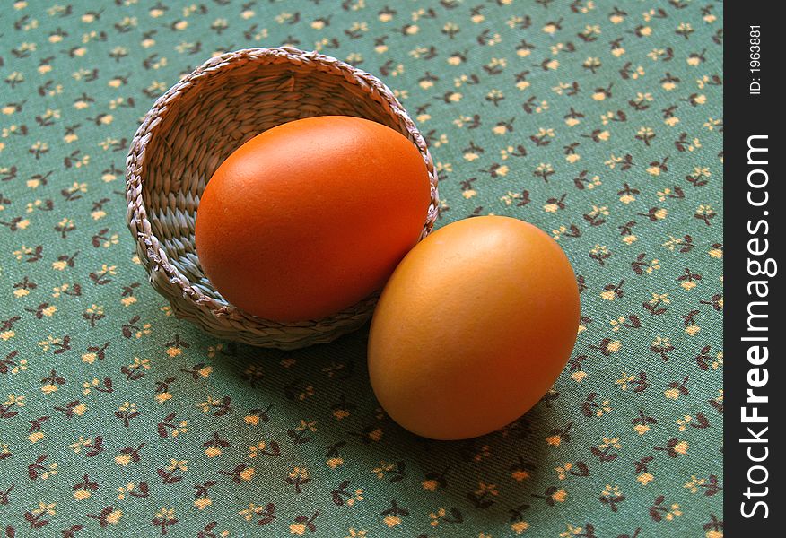 Two painted eggs with basket on green background. Two painted eggs with basket on green background