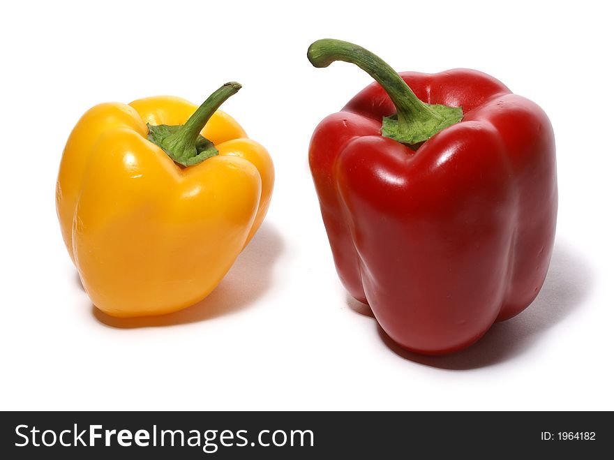 Yellow sweet and red bitter peppers isolated on white background