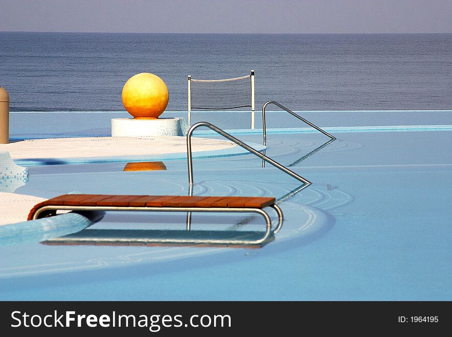 Partial view of the pools of a hotel with a yellow ball and the ocean behind in Puerto Vallarta, Jalisco, Mexico, Latin America