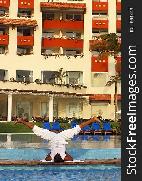 Partial view of a hotel in Puerto Vallarta with Yoga teacher on a wooden bridge between two pools, Jalisco, Mexico, Latin America