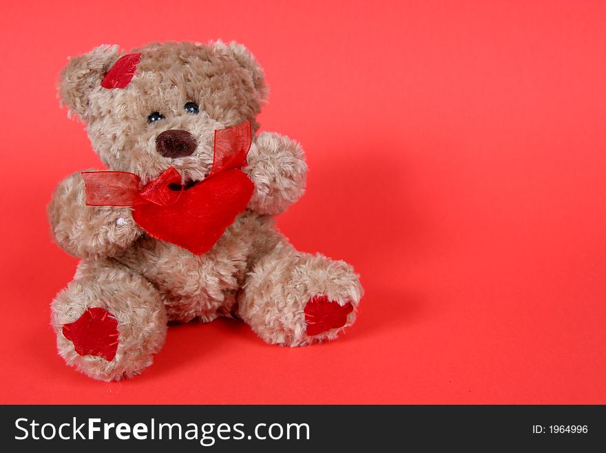 Brown Teddy Bear with hearts on red background. Brown Teddy Bear with hearts on red background