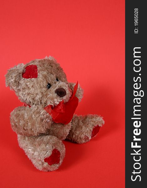 Brown Teddy Bear with hearts on red background. Brown Teddy Bear with hearts on red background