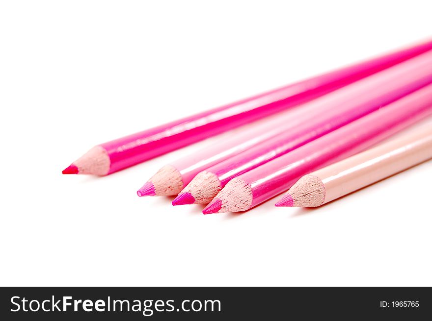 Row of spectrum of pink color pencils on a white background