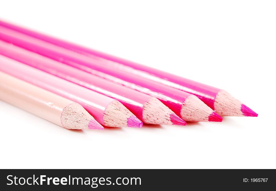 Row of spectrum of pink color pencils on a white background