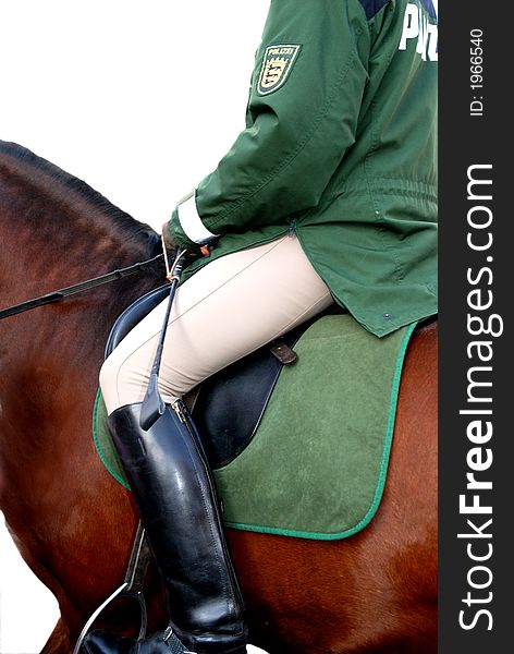 A german Policewoman is riding on a horse. A german Policewoman is riding on a horse