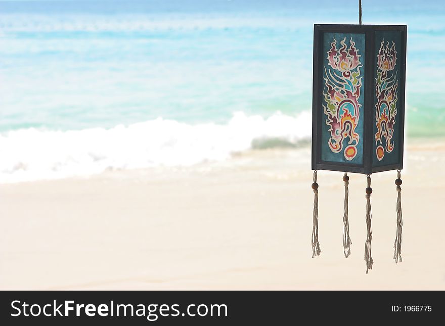 Ethnic style lantern hanging with the ocean in the background. Ethnic style lantern hanging with the ocean in the background