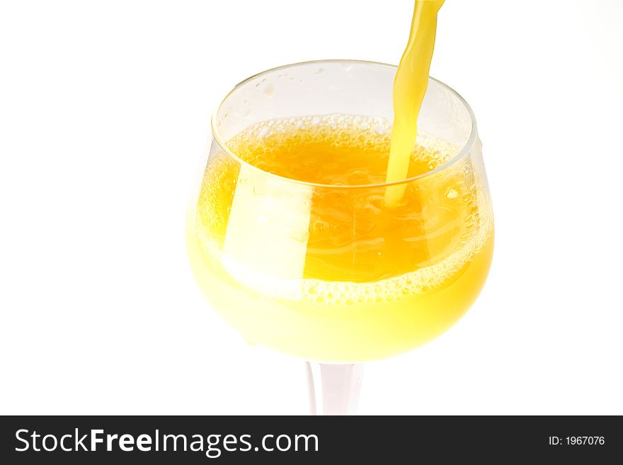 Fresh brightly yellow orange juice in glass on a white background