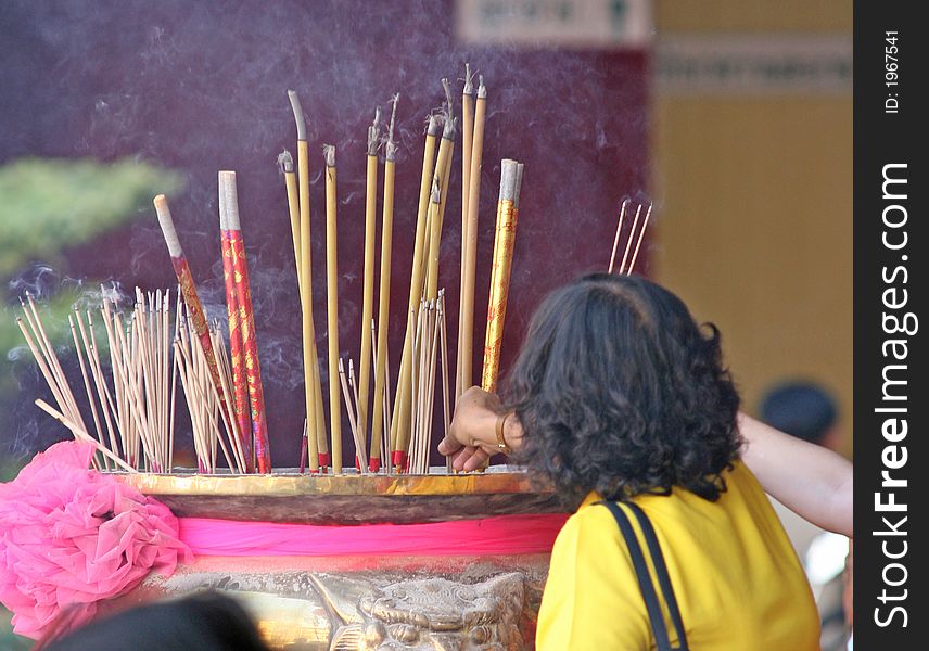 Burning incense in a temple to bring good luck during Chinese New Year