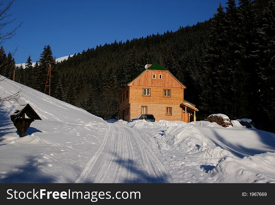 Wooden cottage on mountains in winter