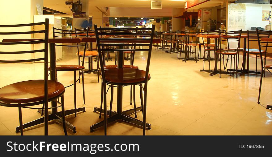 Morning view of a food court in Malaysia showing rows of empty seats