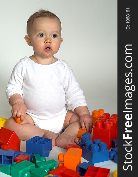 Image of cute baby playing with colorful building blocks. Image of cute baby playing with colorful building blocks