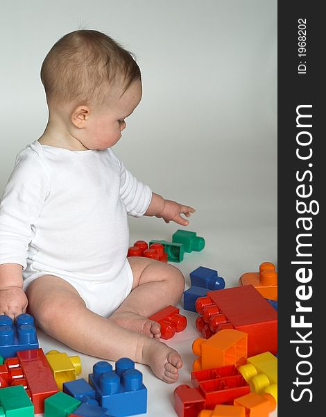 Image of cute baby playing with colorful building blocks. Image of cute baby playing with colorful building blocks