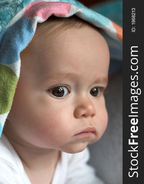 Image of baby peeking out from under a blanket. Image of baby peeking out from under a blanket