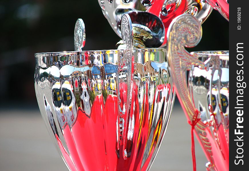 Rally Trophy with rally cars reflected on it. Rally Trophy with rally cars reflected on it