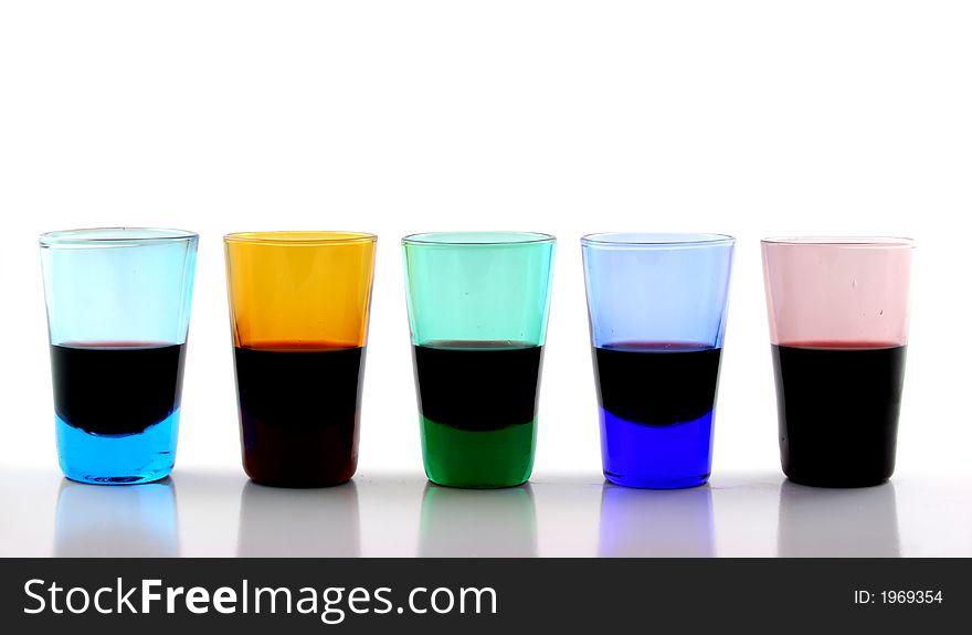 Close up of brightly colored drinking glasses with wine in them. Close up of brightly colored drinking glasses with wine in them