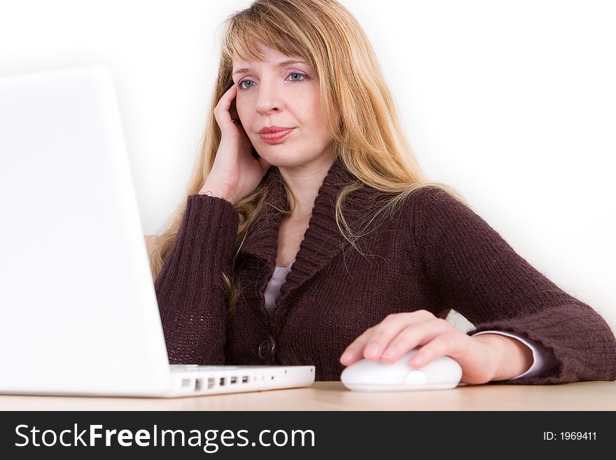 A blond woman using a laptop isolated against a white background. A blond woman using a laptop isolated against a white background