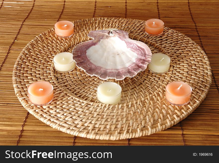 Candles in a circle with a sea shell in the middle. Candles in a circle with a sea shell in the middle