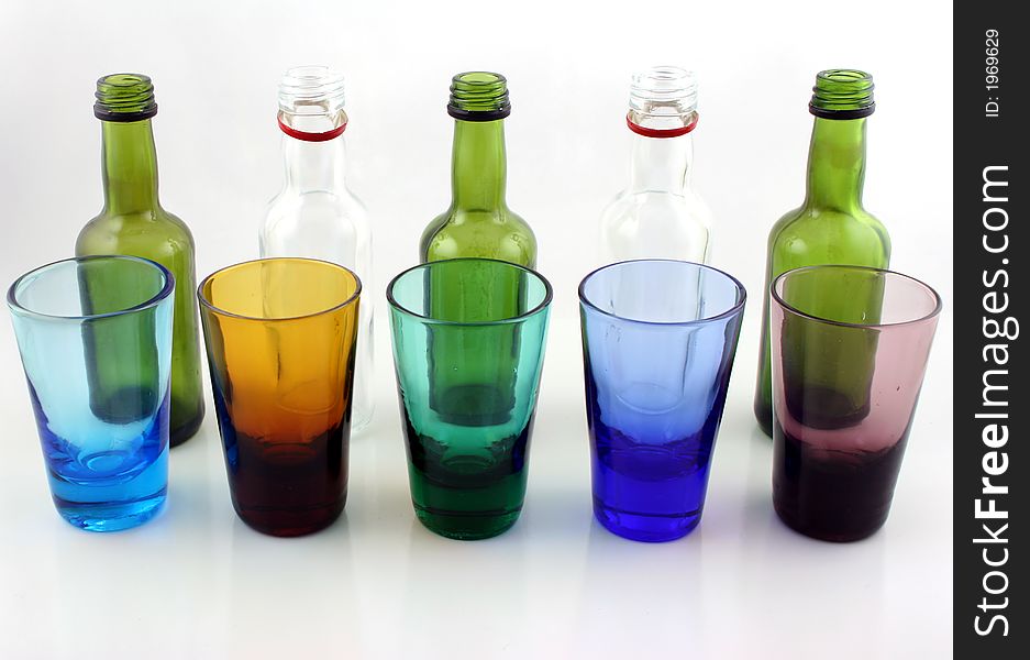 Close up of brightly colored drinking glasses and mini bottles. Close up of brightly colored drinking glasses and mini bottles