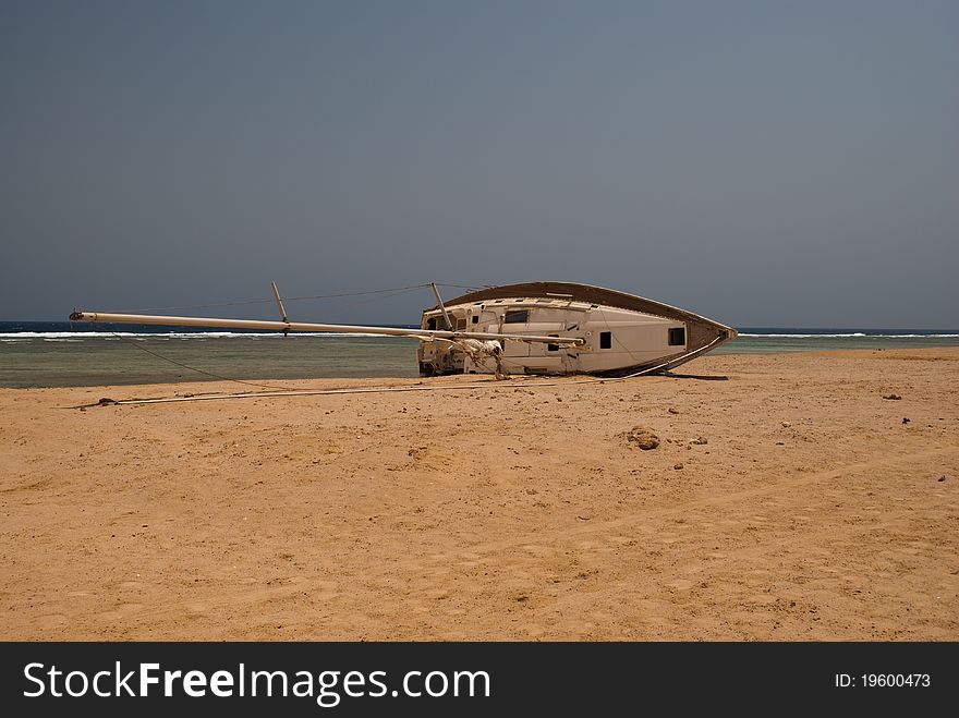 Abandoned sail boat on a beach in marsa alam, egypt. Abandoned sail boat on a beach in marsa alam, egypt