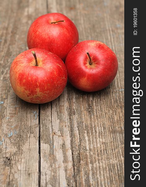 Red ripe apple on old wooden background