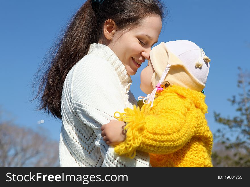 Little girl with mother in spring park