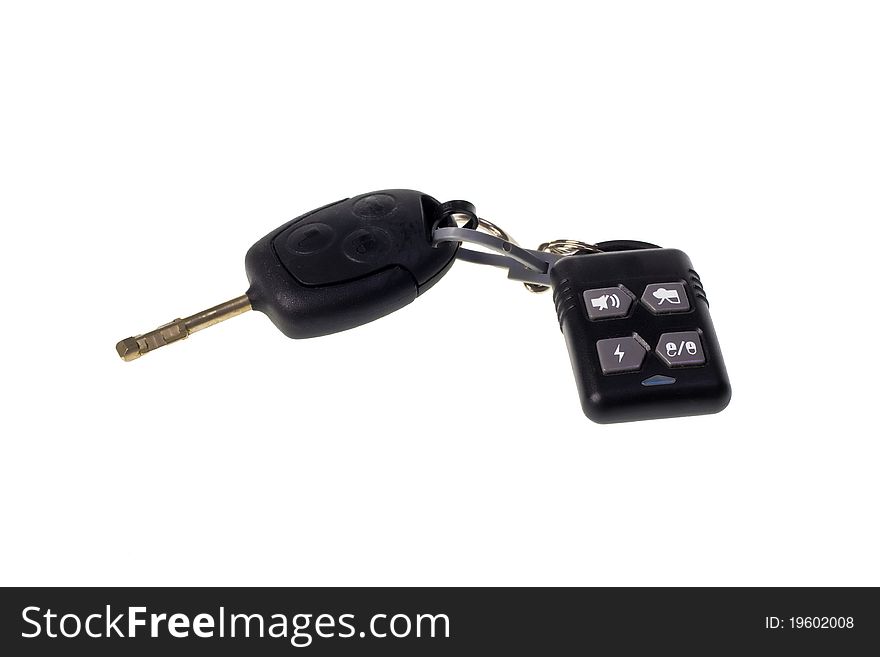 Automobile key with the panel from the alarm system on a white background. Automobile key with the panel from the alarm system on a white background