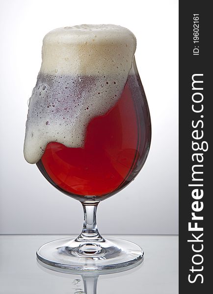 Bubbling red beer in full glass. Bubbling red beer in full glass