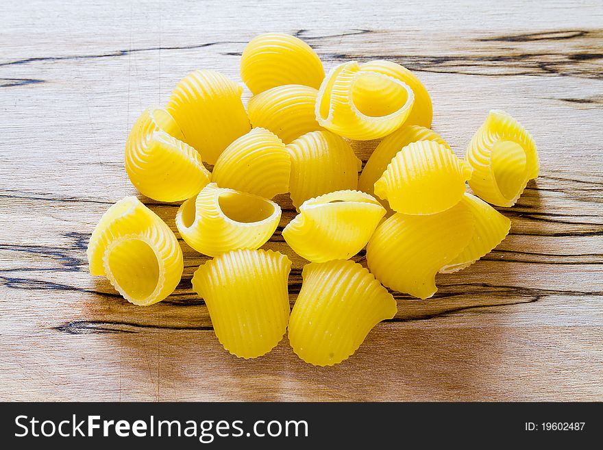 Raw shell pasta on the wood table