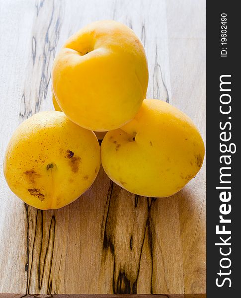 Closeup of apricots on wood table