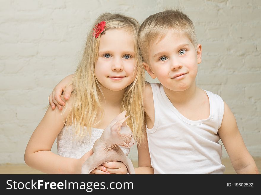 Portrait of beautiful children twins with kitten at home. Portrait of beautiful children twins with kitten at home