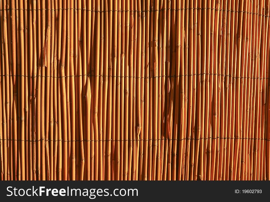 Abstract reed yellow fence on the wall. Abstract reed yellow fence on the wall