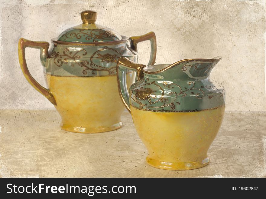 Lovely textured image of an antique creamer and sugar-bowl. Lovely textured image of an antique creamer and sugar-bowl
