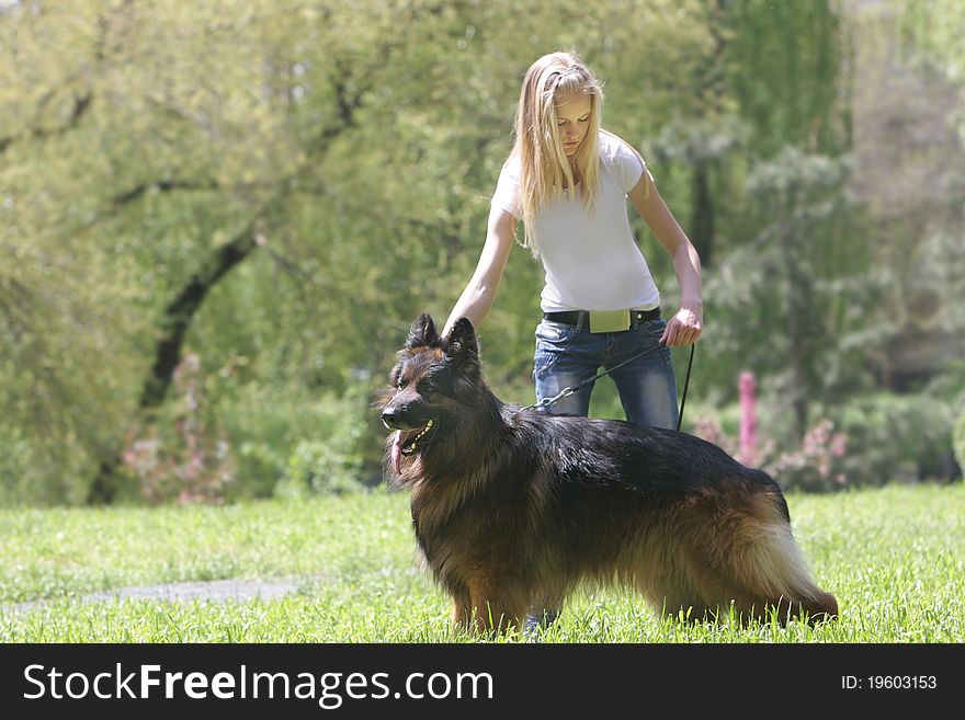 Young woman with dog on natural background