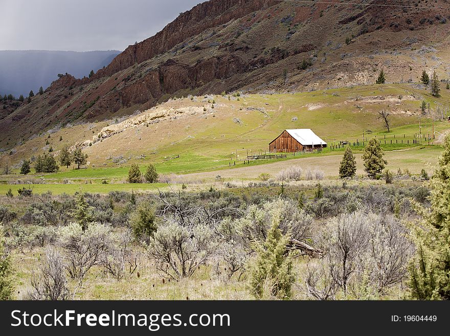 Barn at base of mountain.