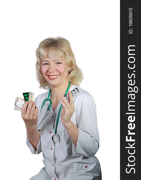 The woman,  blonde,  doctor with a stethoscope on a neck, shows medicines and smiles  Ð¾n isolated. The woman,  blonde,  doctor with a stethoscope on a neck, shows medicines and smiles  Ð¾n isolated