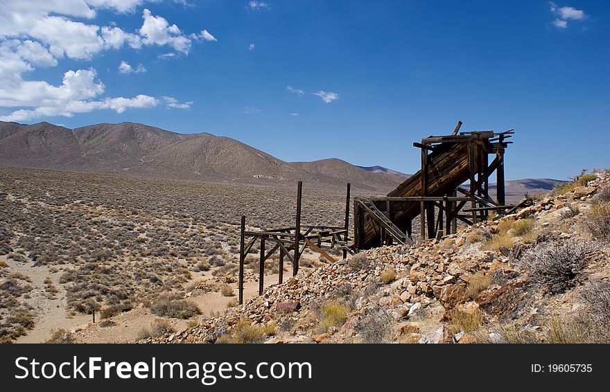 The antique remains of a gold mine built in the early 1900's clings to the side of a hill in Death Valley National Park. The antique remains of a gold mine built in the early 1900's clings to the side of a hill in Death Valley National Park.