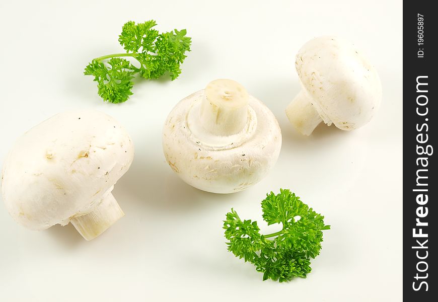 Champignon mushroom with parsley, isolated towards white background. Champignon mushroom with parsley, isolated towards white background