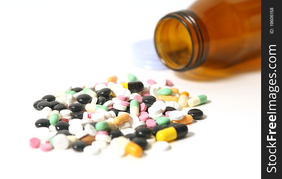 Pills and capsules with open bottle