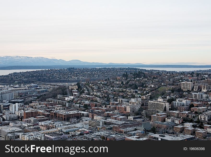 Aerial view overlooking the city skyline of Seattle Washington with mountain ranges on distant horizon. Aerial view overlooking the city skyline of Seattle Washington with mountain ranges on distant horizon