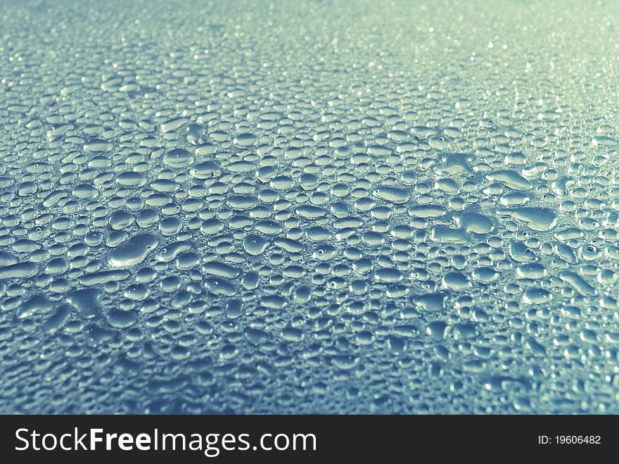 Water droplets on smooth glass surface