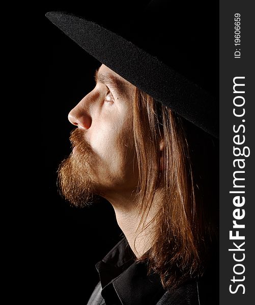 Man in hat, looking up, profile