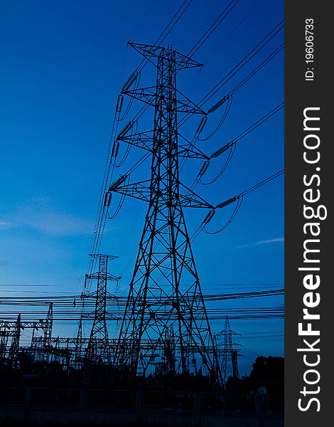 High voltage electricity pillars and blue sky before sunrise