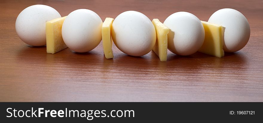 Cheese and eggs a semicircle on a table