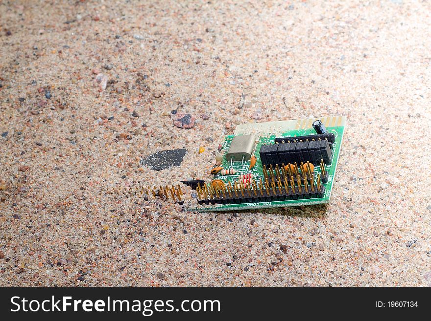 Out-of-date sound card in sand close up. Out-of-date sound card in sand close up