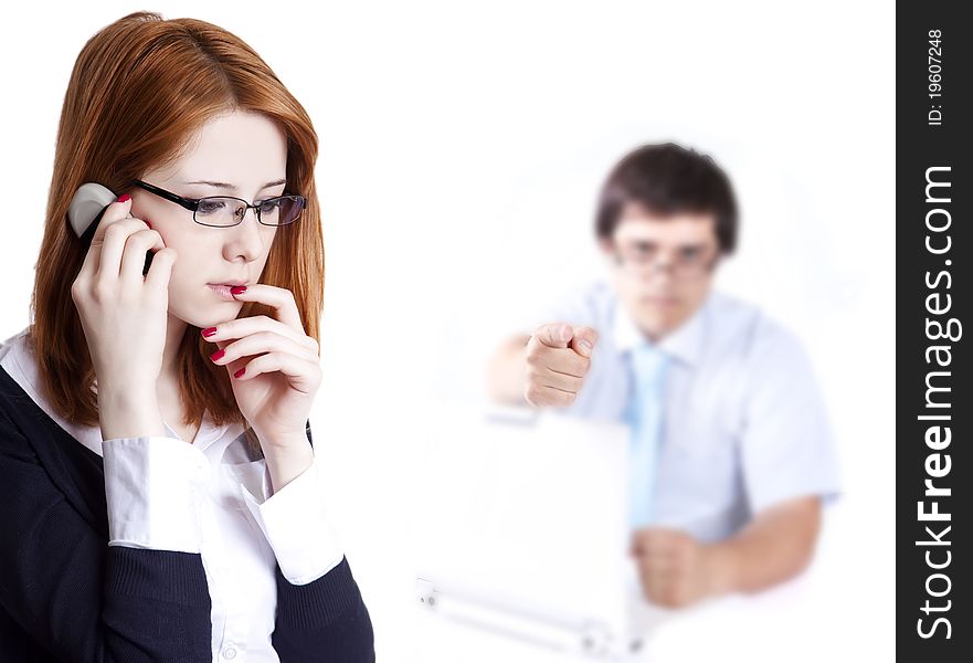 Sad business women calling by phone and boss at background point at her. Sad business women calling by phone and boss at background point at her.