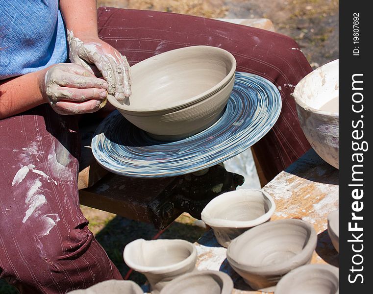 Potter hands working on pottery wheel