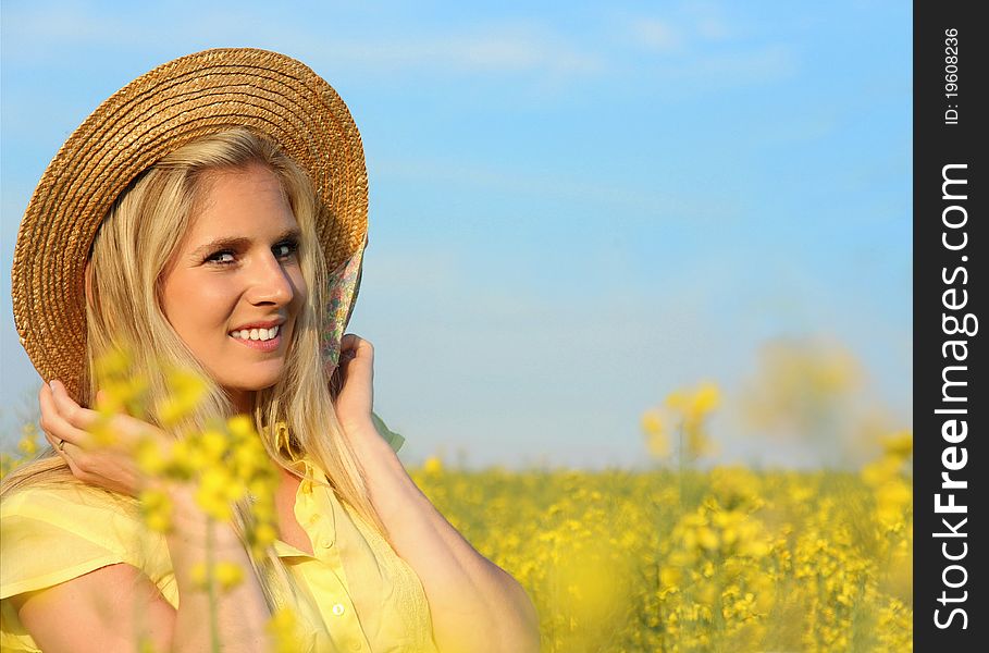 Happy blond girl in blooming field. Happy blond girl in blooming field