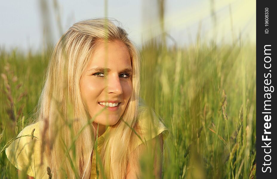 Beautiful blond girl in grass with sunshine. Beautiful blond girl in grass with sunshine